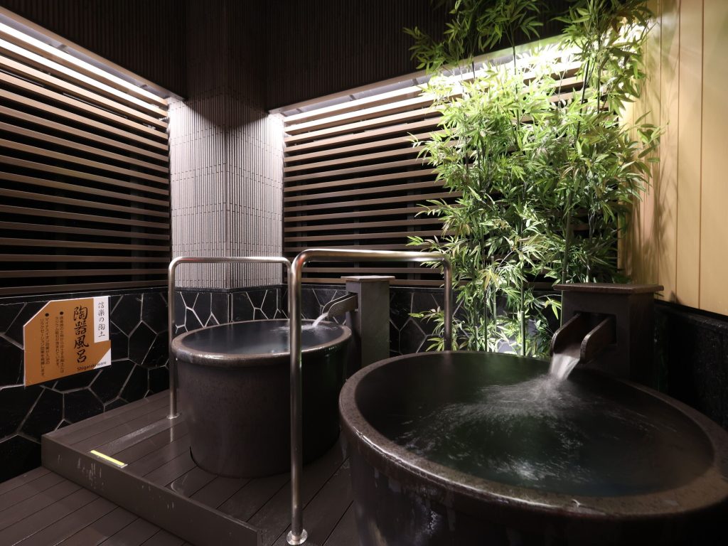 The private onsen available in APA Hotel Ueno Ekimae. There are two private onsen tubs with flowing water and natural accents from plants and wood.