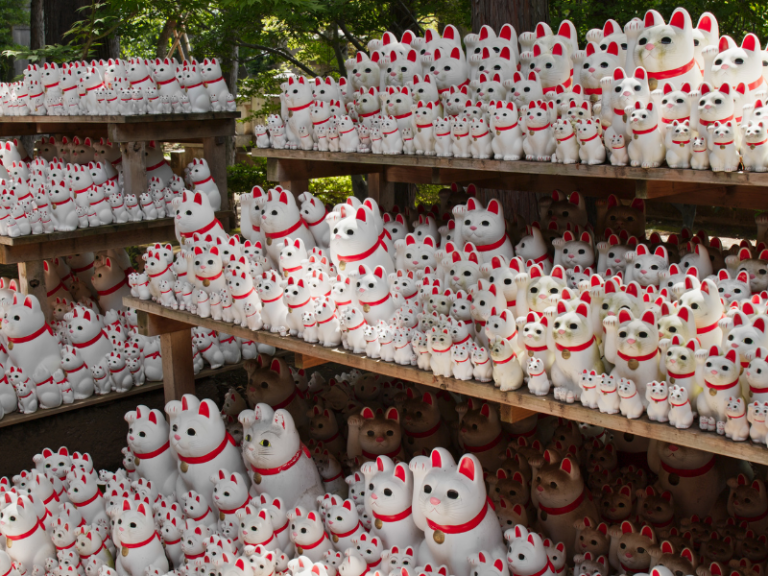 A collection of lucky cat statues (maneki-neko) at Gotokuji Temple, known as the birthplace of the iconic figurine that brings good fortune.