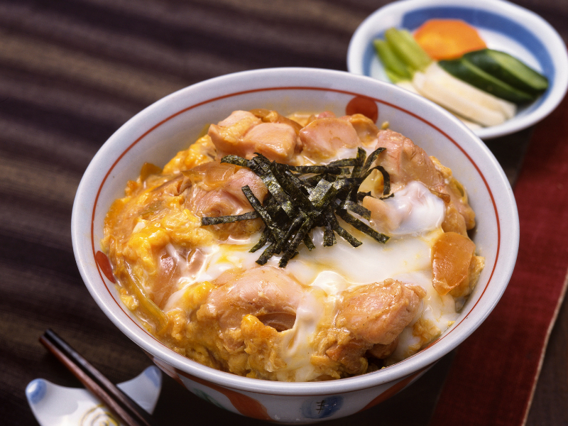 Oyako-don, a Japanese dish made with chicken, egg, and sliced onions, simmered together in a savory dashi-based broth