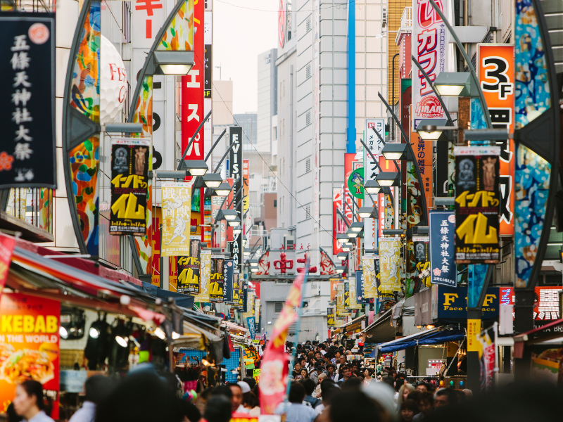 Ueno Ameyoko in Tokyo, Japan. It is a crowded street with lots of bargain shop signs.