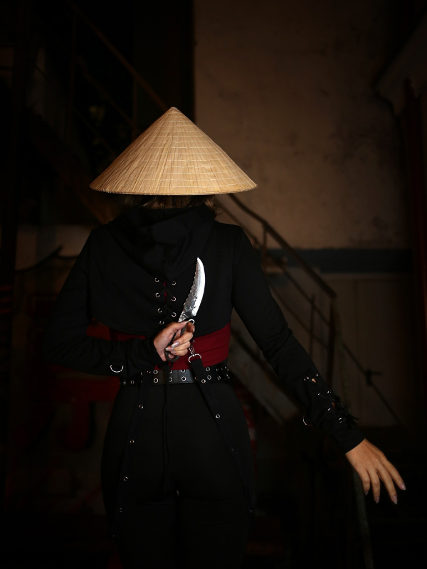 A ninja holding a knife, poised to attack at Ninja Trick House in Tokyo.