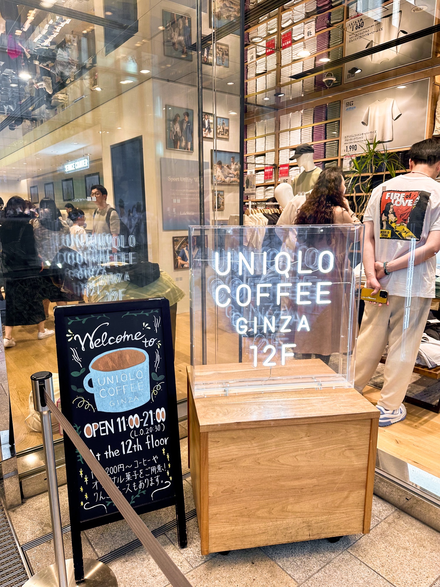 The entrance to the Uniqlo Flagship store in Ginza, Tokyo. There is a sign saying UNIQLO Coffee on the 12th floor.