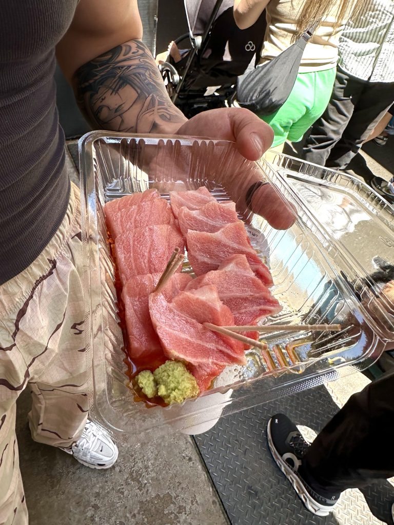 A plate of six thick, marbled slices of fresh toro belly served at a food stall in Tsukiji Market.