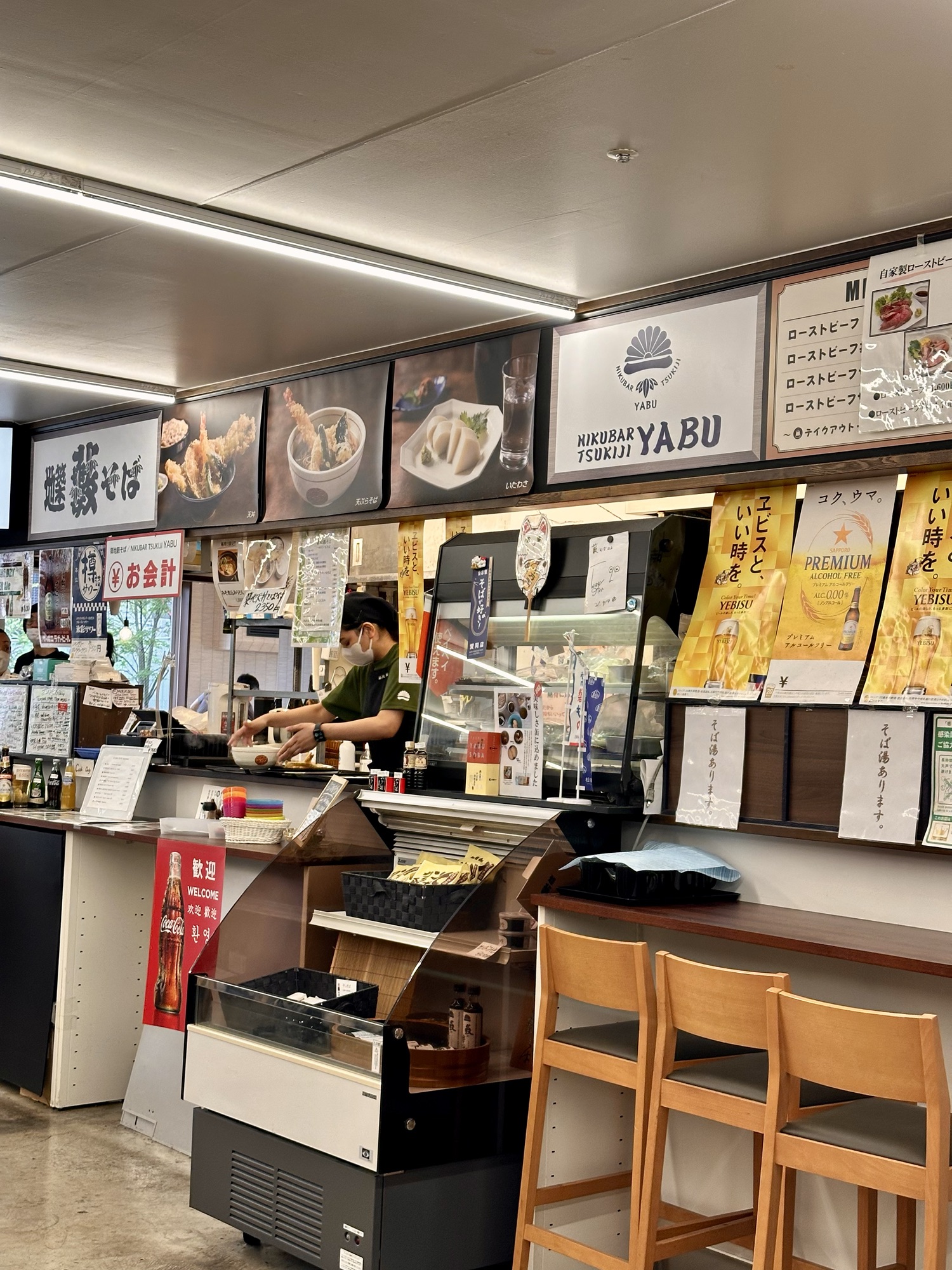 Hidden udon restaurant located upstairs in Tsukiji Market, featuring a cozy atmosphere with traditional wooden decor, offering freshly made udon noodles.