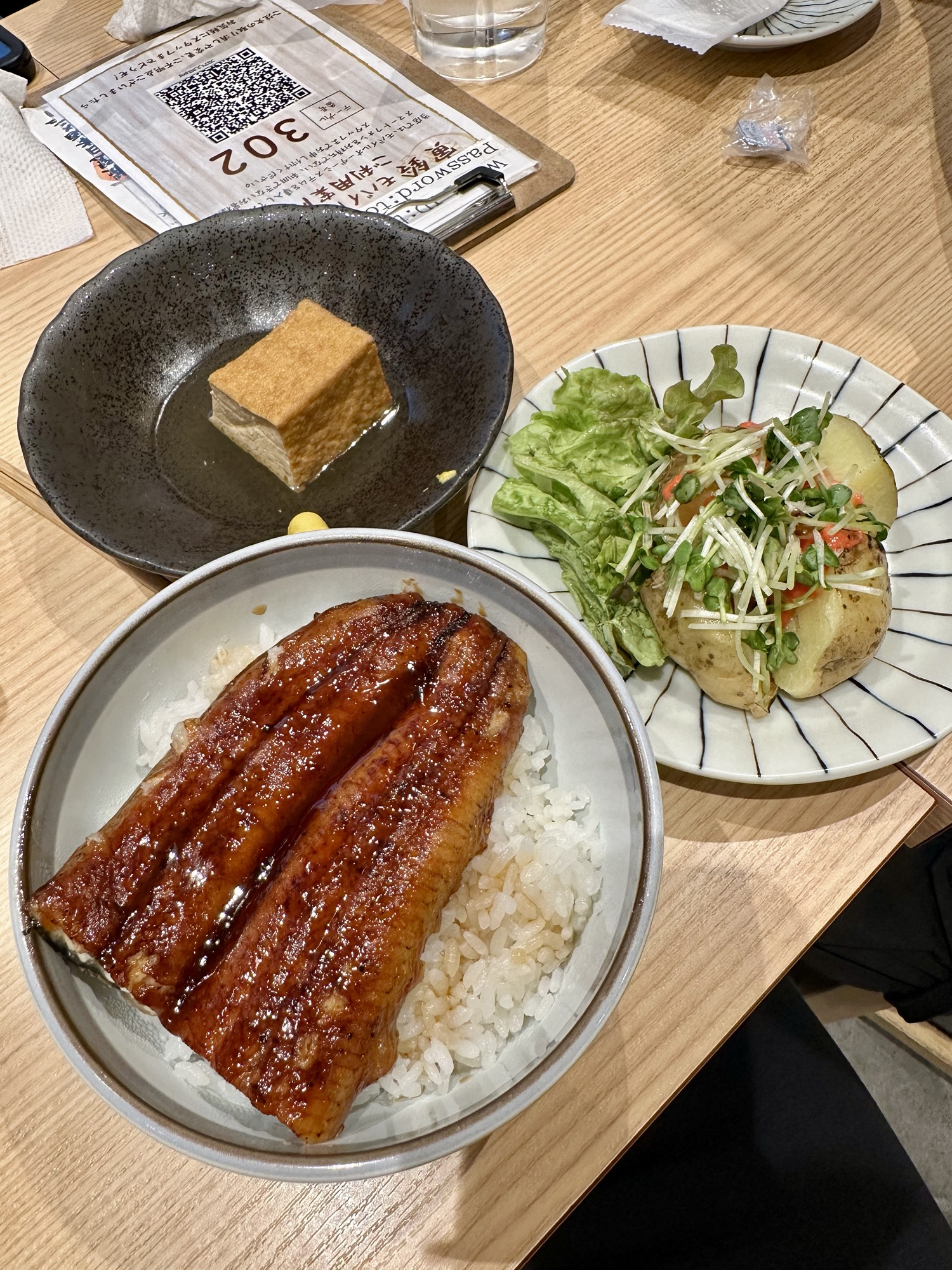 A unagi bowl, tofu, and salad in Torasuzu in Asakusa, Tokyo.