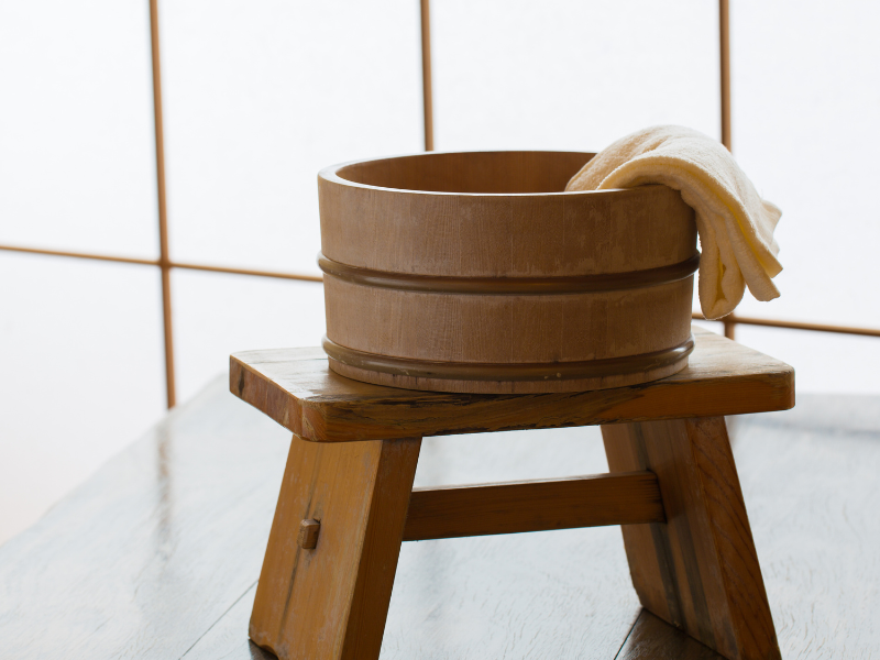 A stool typically used in Japanese onsen, with a wash basin and towel.