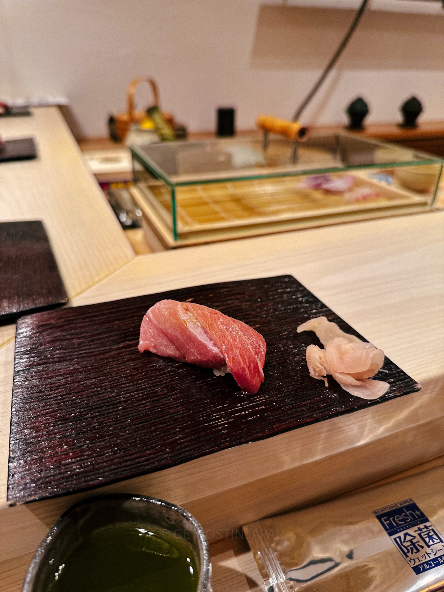 Tuna belly omakase served on a brown wooden plate in a Japanese restaurant in Tokyo, Japan.