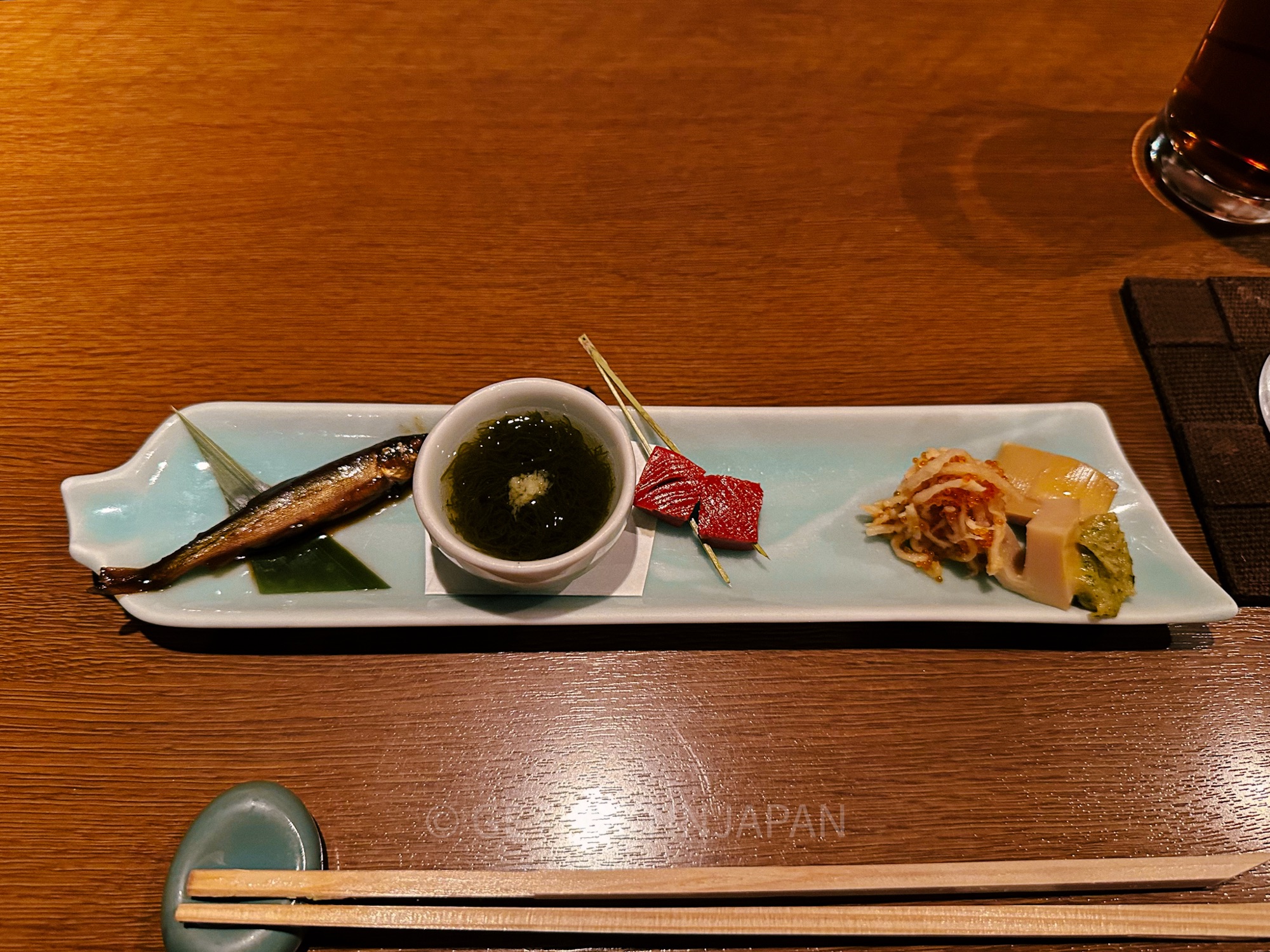 An appetizer for a kaiseki meal in Hanasaki restaurant in Kyoto. There is a small fish, with local pickled vegetables.