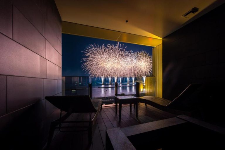 Private balcony at Atami Pearl Star Hotel with stunning ocean view and fireworks—perfect for a one day in Atami itinerary.