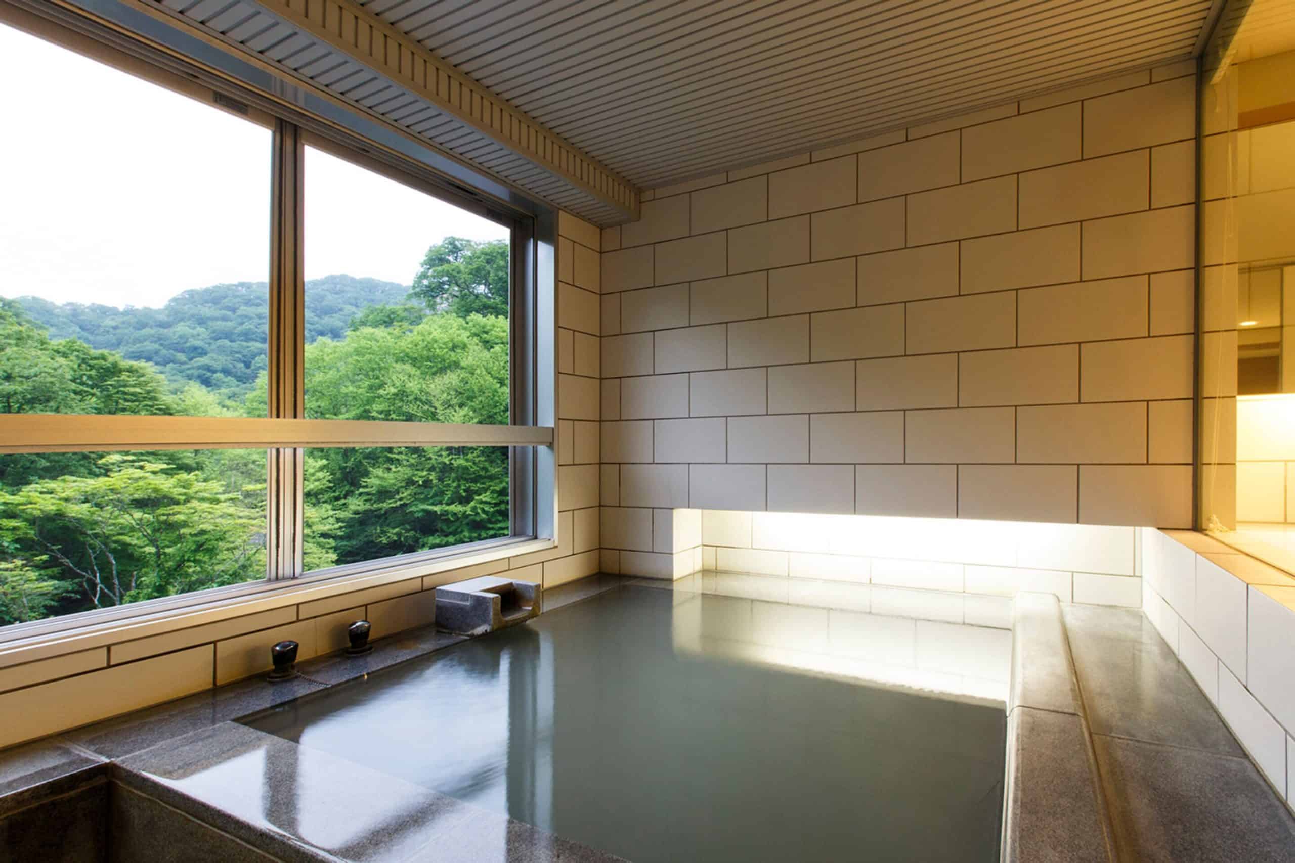 Luxurious private indoor onsen with forest views at Bourou Noguchi Noboribetsu, a tranquil escape for those looking for 5 star hotels in and around Sapporo.