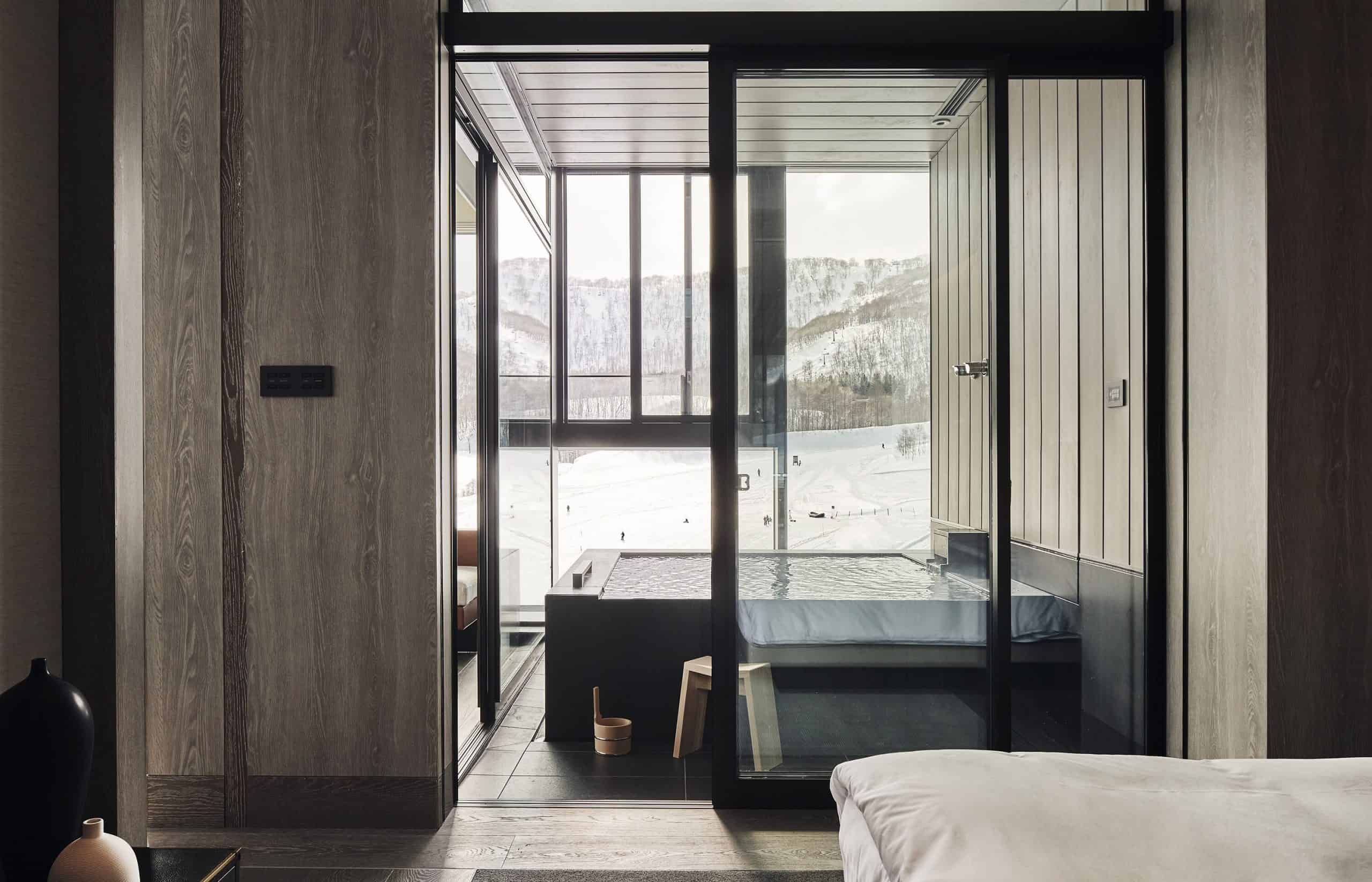 Exclusive in-room onsen overlooking ski slopes, capturing the winter magic and spa luxury offered by Park Hyatt Niseko Hanazono, a 5 star resort hotel nearby Sapporo.