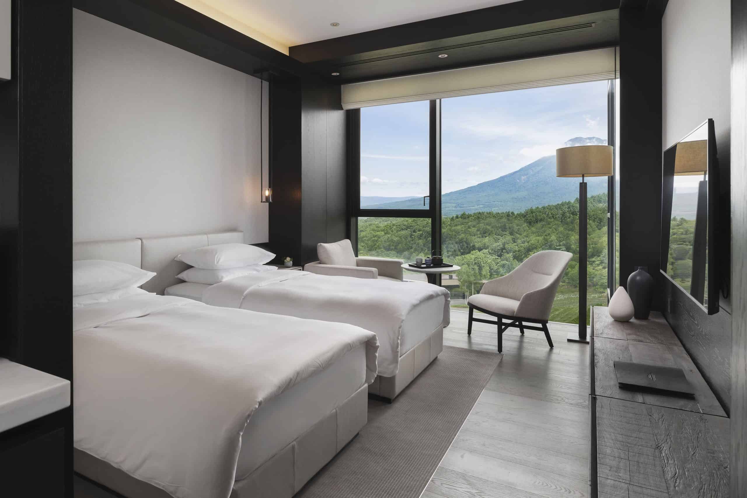 Sophisticated guest room at Park Hyatt Niseko Hanazono, featuring twin beds and panoramic views of Mount Yotei—an exceptional experience near the finest 5 star hotels in Sapporo.