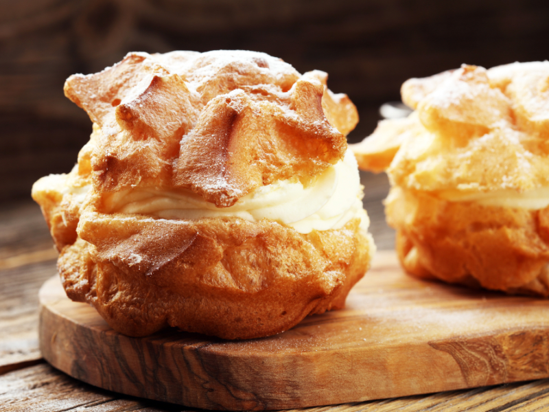 A fluffy, golden cream puff filled with rich custard cream from Kitakaro—one of Sapporo’s most beloved desserts made with Hokkaido dairy.