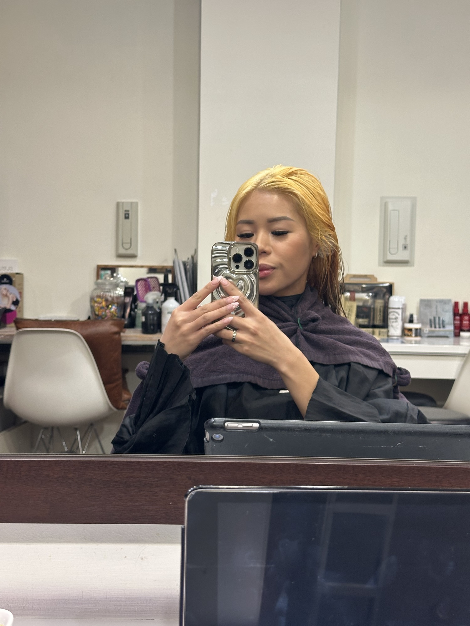 A girl with bright yellow orange hair after a bleaching session in Number 76 Hair Salon in Tokyo, an English Speaking hair salon in Tokyo.