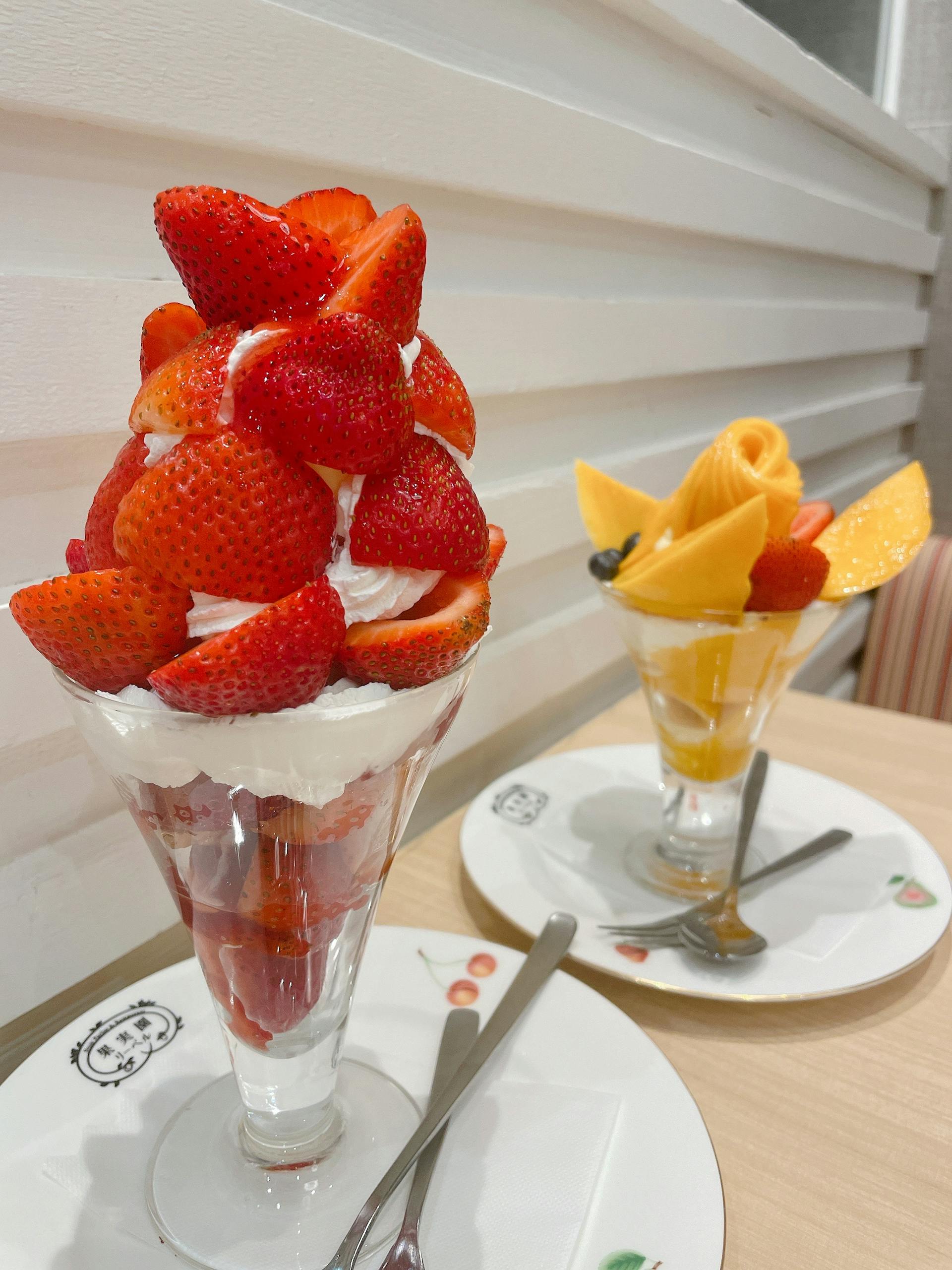 Tempting fruit parfaits with strawberries and mangoes, perfect for a sweet treat in Japan.