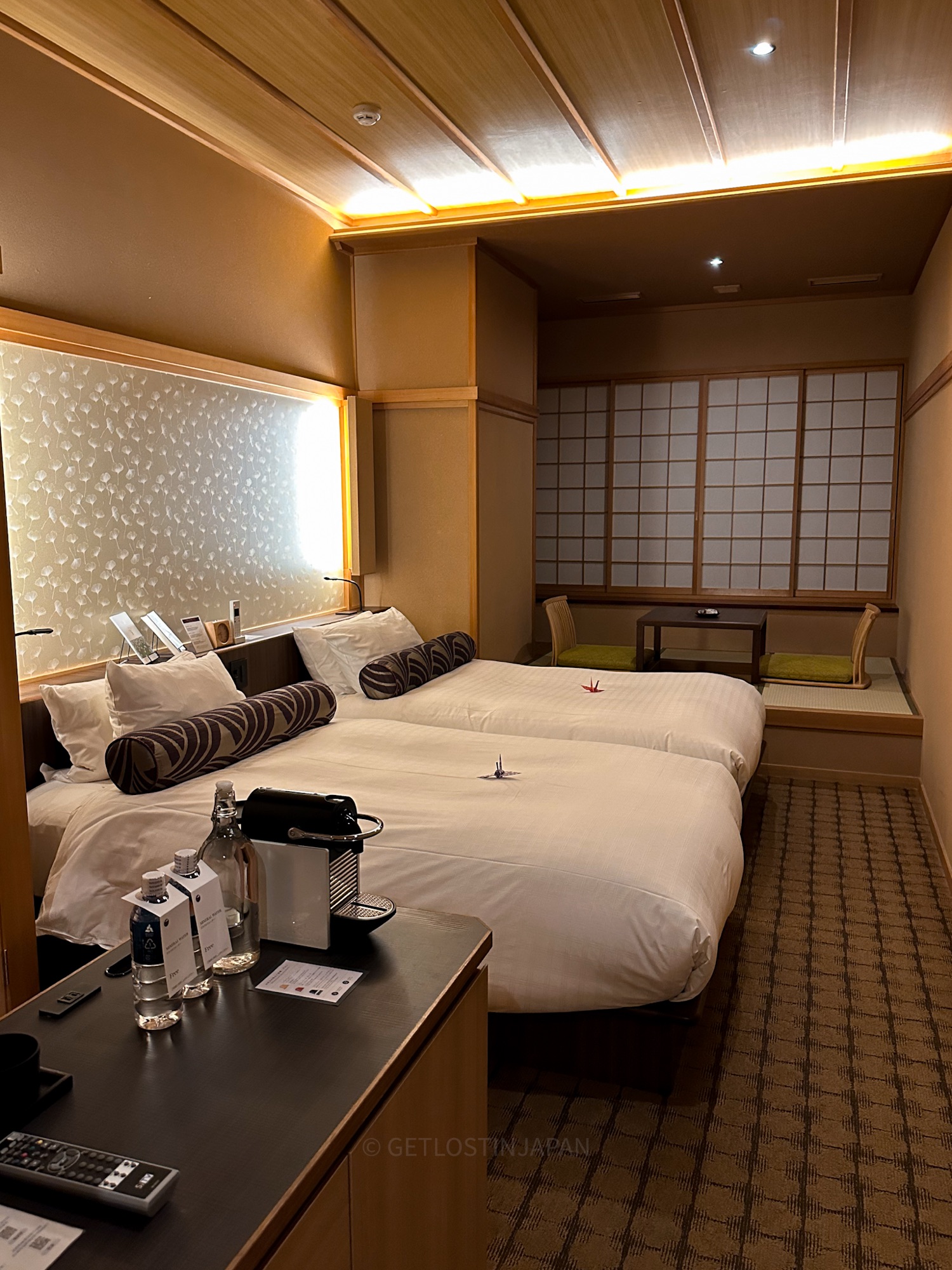 Wide-angle view of Saka Hotel Kyoto superior twin room with shoji screens and tatami-style sunken hori-gotatsu table.