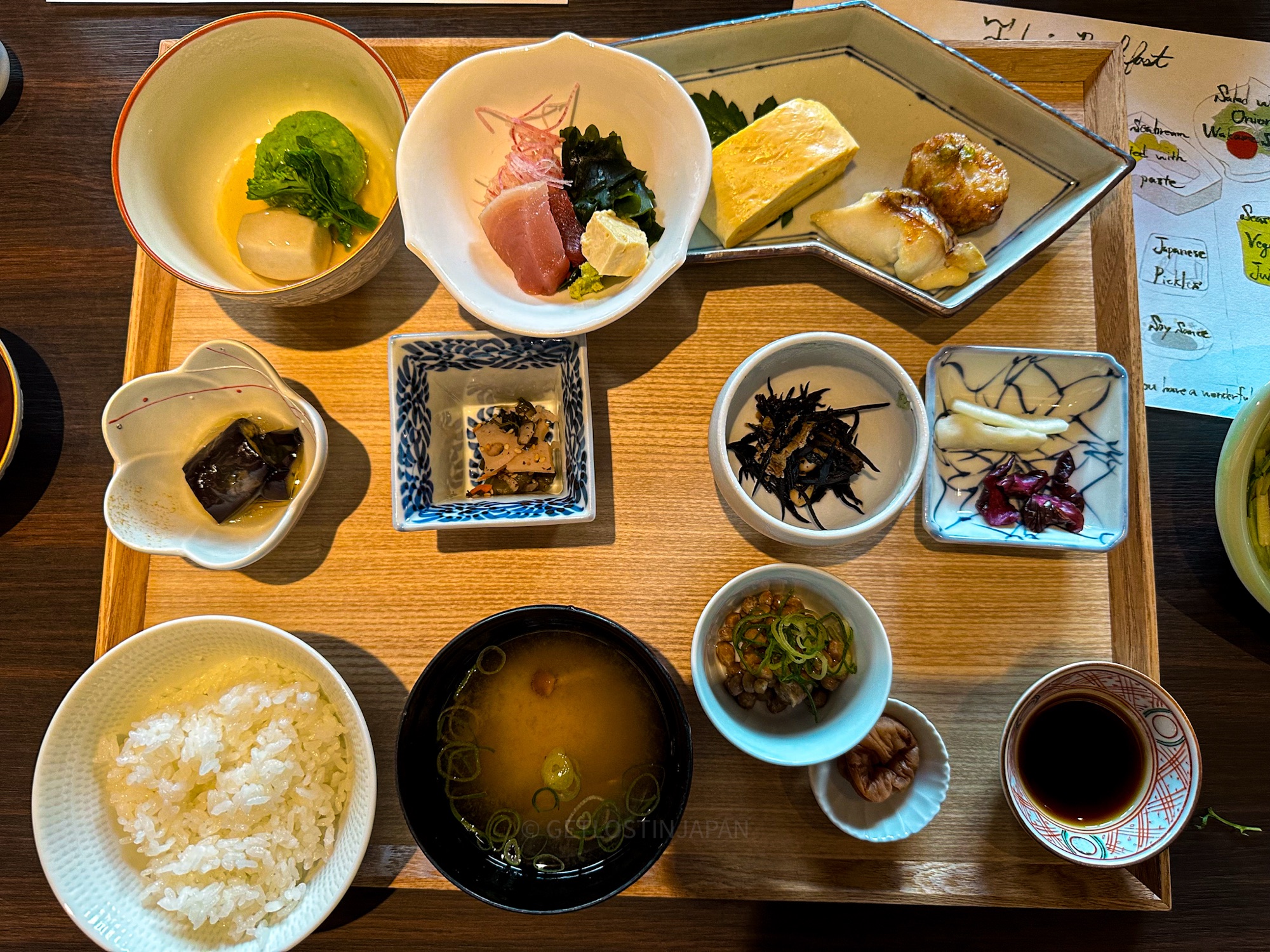 Illustrated Japanese breakfast menu at Saka Hotel Kyoto featuring sashimi, miso soup, and more