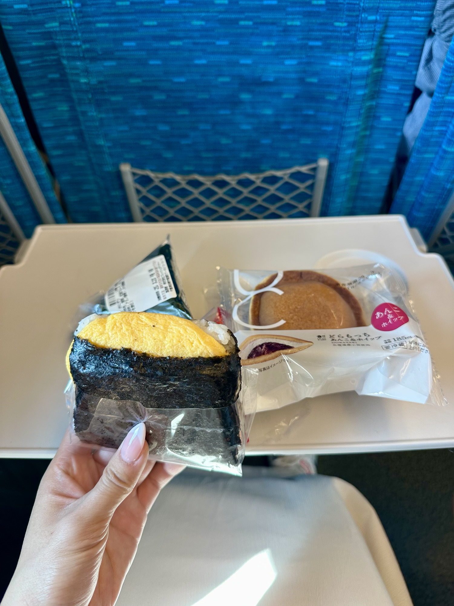 Convenience store breakfast with onigiri and dorayaki on the Shinkansen—an easy travel meal during your Arashiyama itinerary.