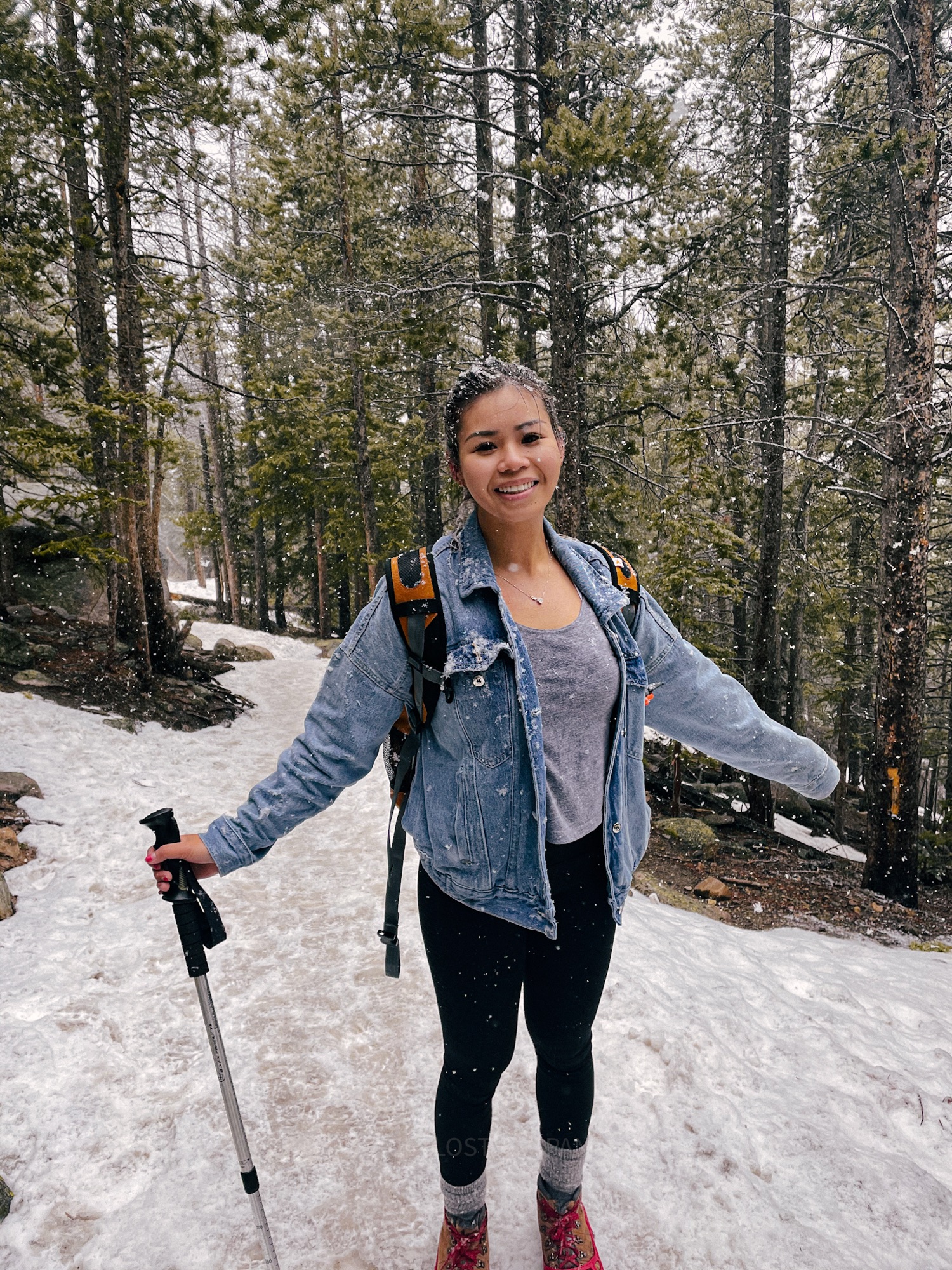 Audrey hiking through a snowy forest trail, a peaceful outdoor experience on a Hokkaido winter itinerary.