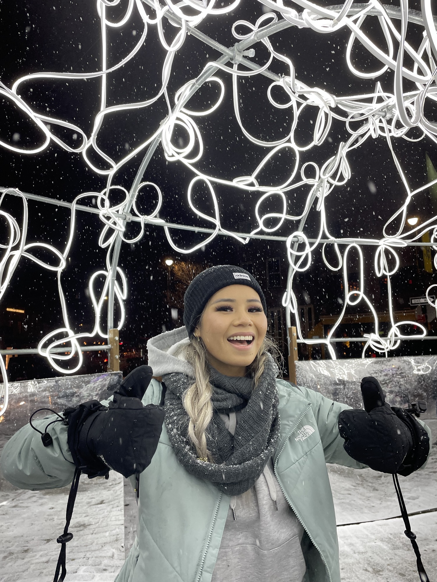 Audrey enjoying snowy night illuminations in Sapporo, a magical highlight of a Hokkaido winter itinerary.