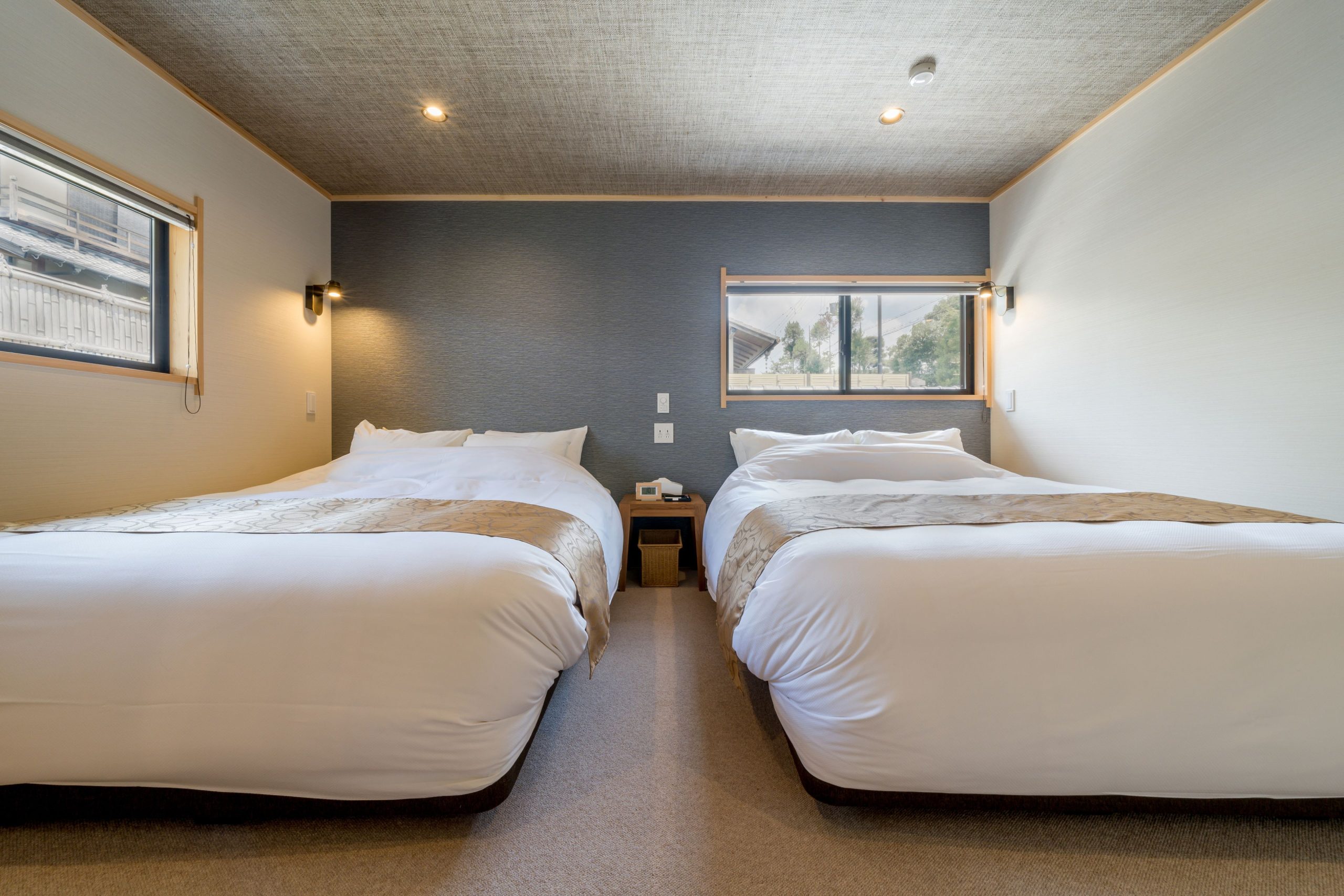 Refined Western-style Arashiyama Benkei Ryokan, with two beds and natural warm lighting.