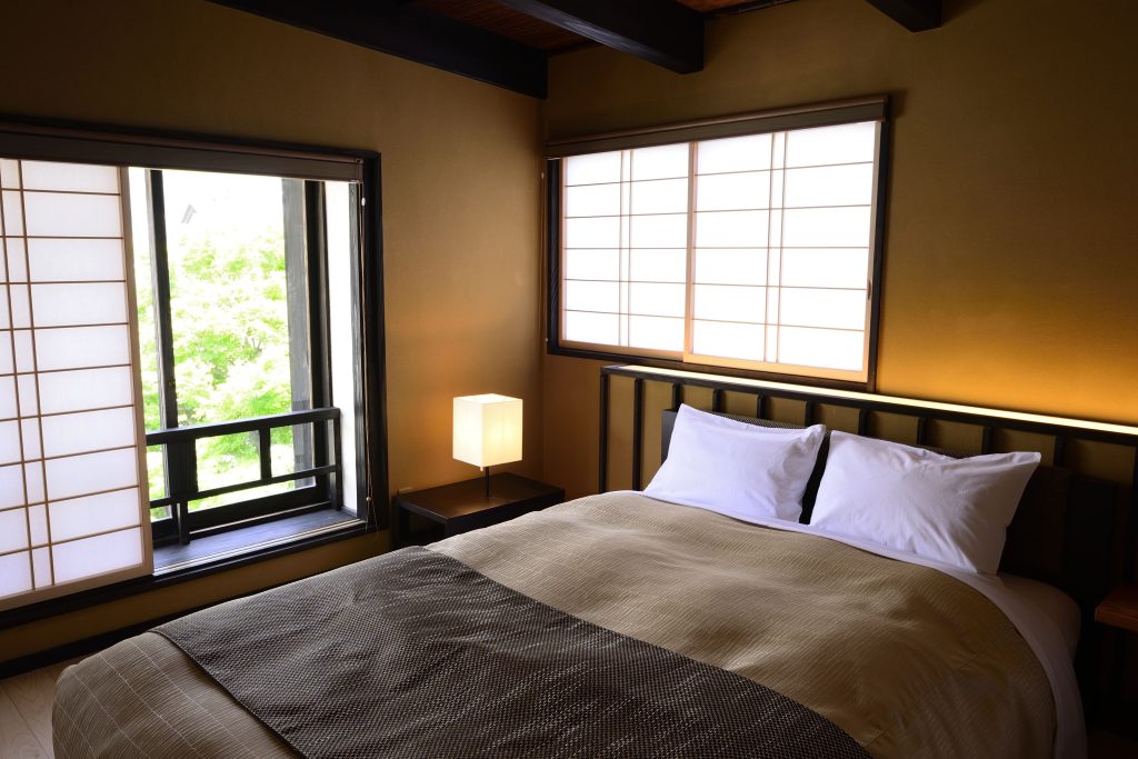 Spacious tatami-style suite with a Western bed at Atami Sekitei, a traditional Atami ryokan surrounded by Japanese gardens.