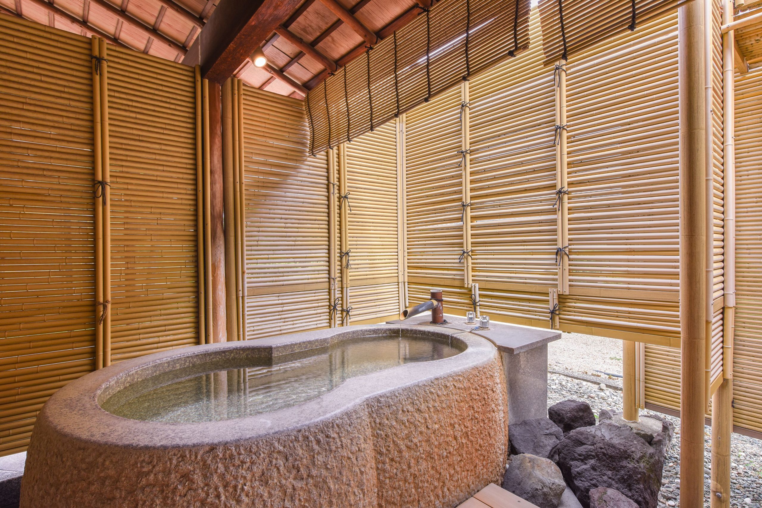 Granite stone open-air bath at Furuya Ryokan, a historic Atami onsen hotel with private onsen options.