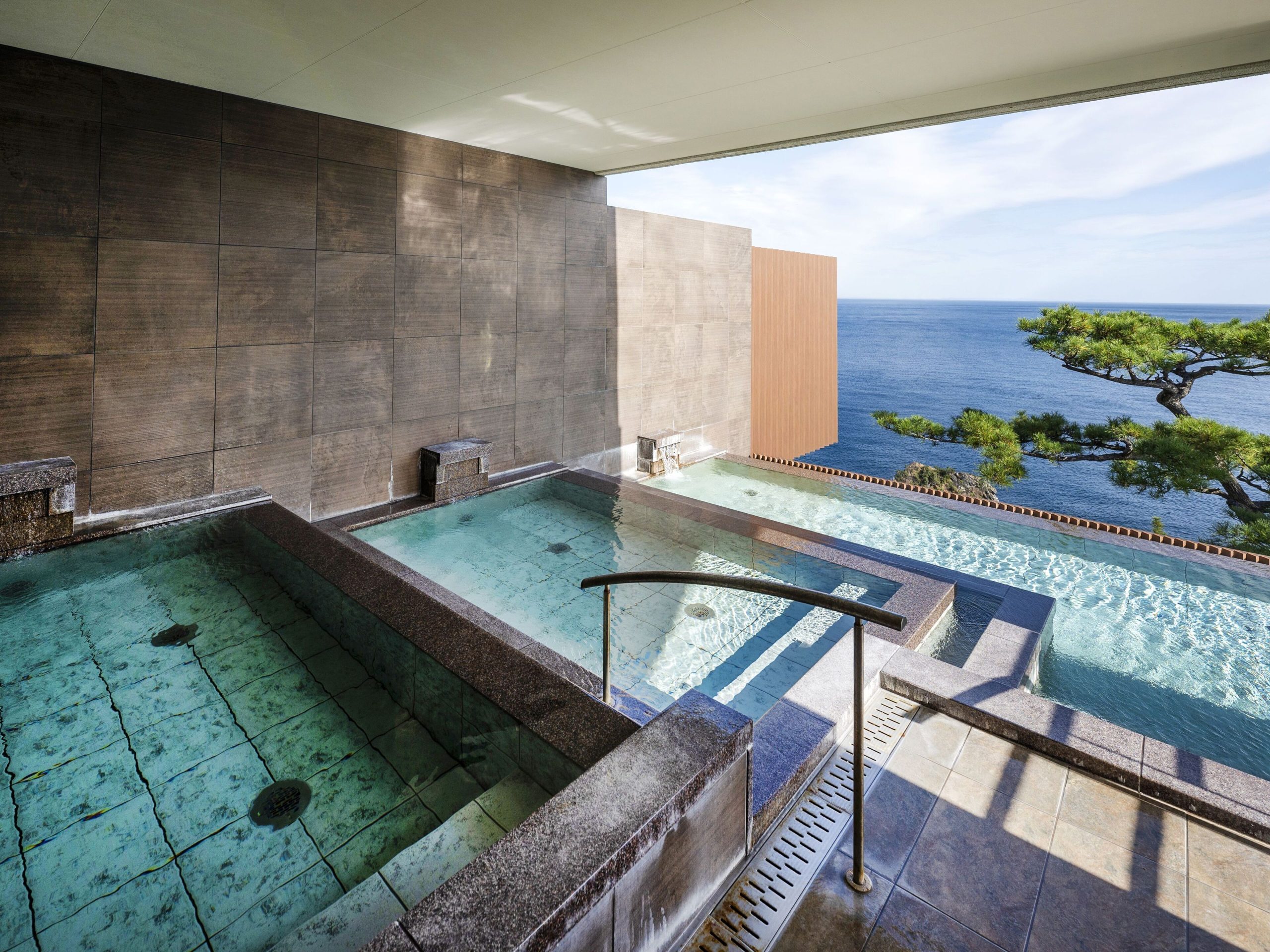 Outdoor onsen overlooking the Pacific Ocean at Hotel New Akao, a famous Atami ryokan experience.