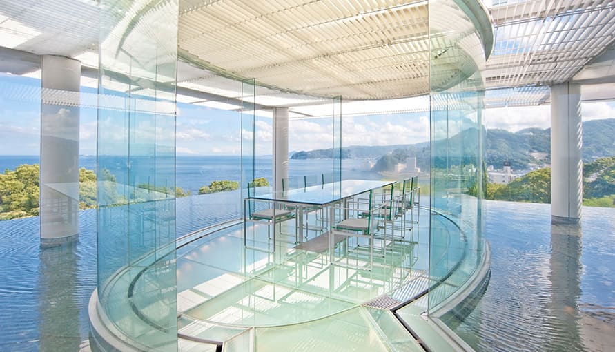 The Water Balcony Dining Room, a modern glass pavilion overlooking the ocean at Kaihourou, a luxury Atami onsen hotel.