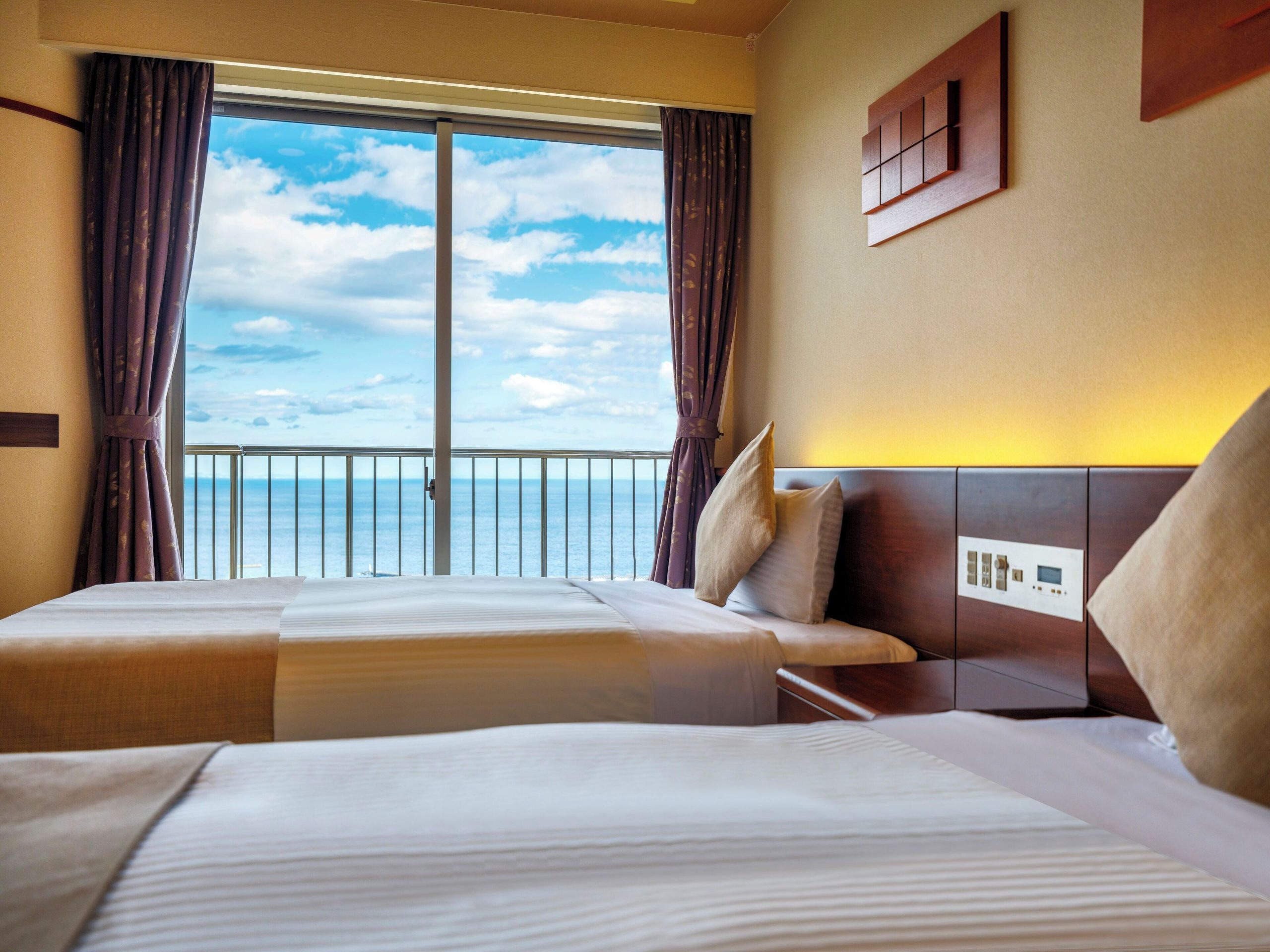 Twin room with ocean view at Kamenoi Hotel Atami, a popular Atami onsen hotel near the coast.