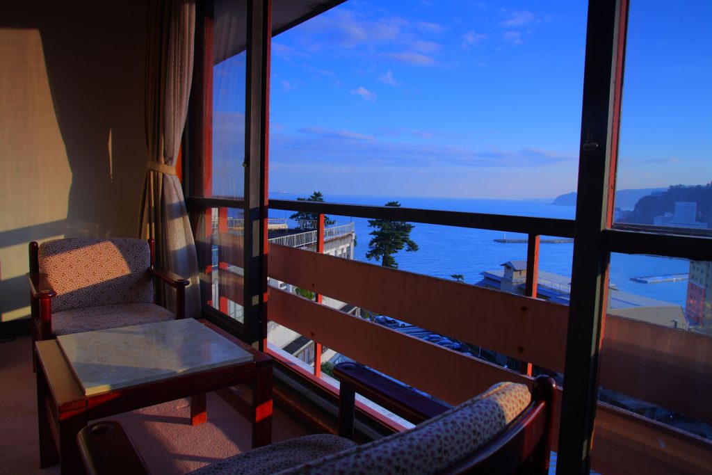 Ocean view seating area at Yuyado Ichibanchi, a cozy Atami ryokan located near the sea.