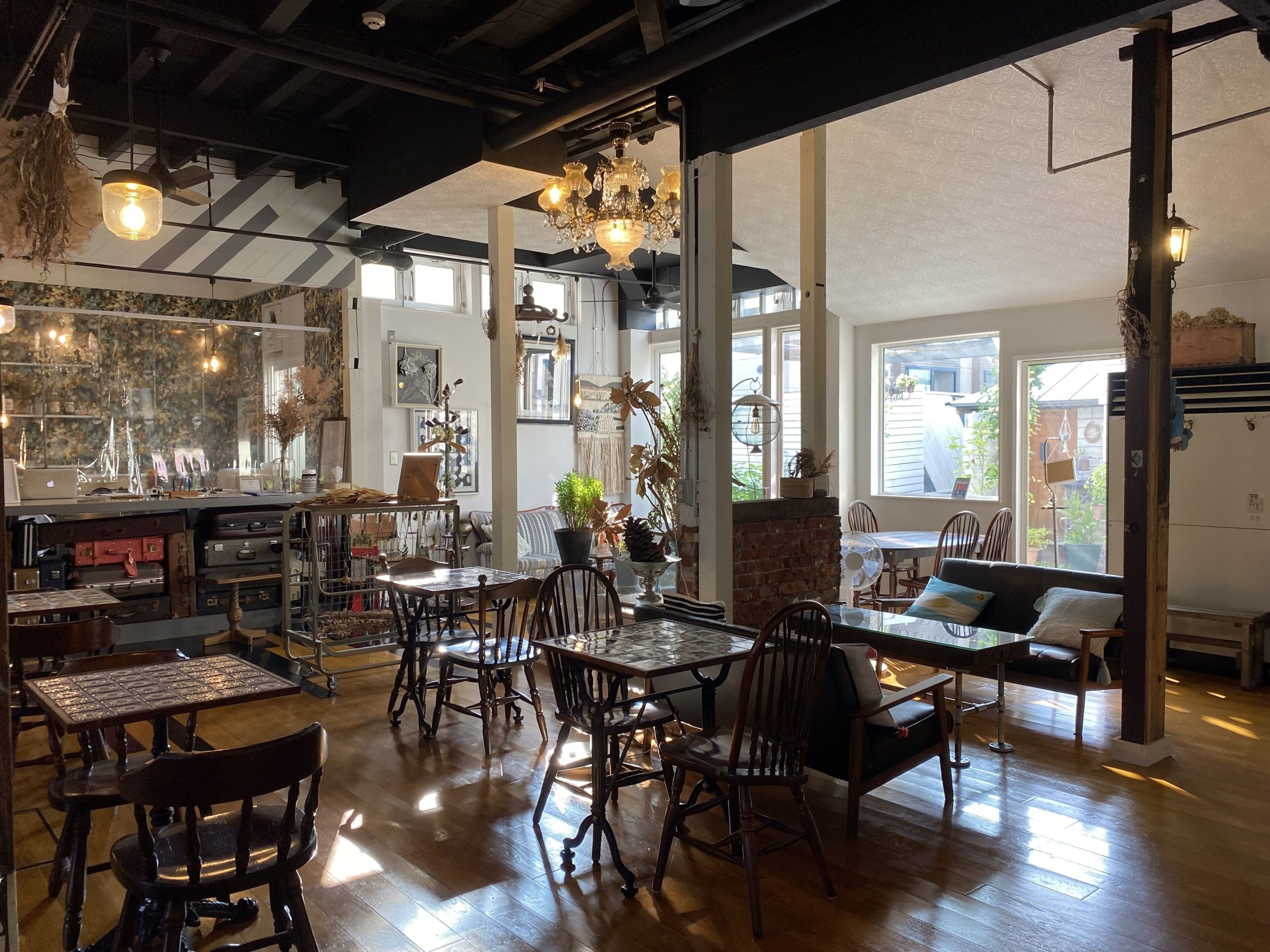 Cozy interior of Little Barrel Café in Otaru, with vintage wooden furniture and warm natural light streaming through the windows — a charming stop on your Otaru day trip from Sapporo.