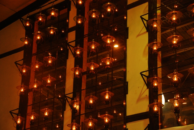 Rows of glowing oil lamps at Kitaichi Glass in Otaru, illuminating the shop’s warm interior — one of the top Otaru things to do for visitors.