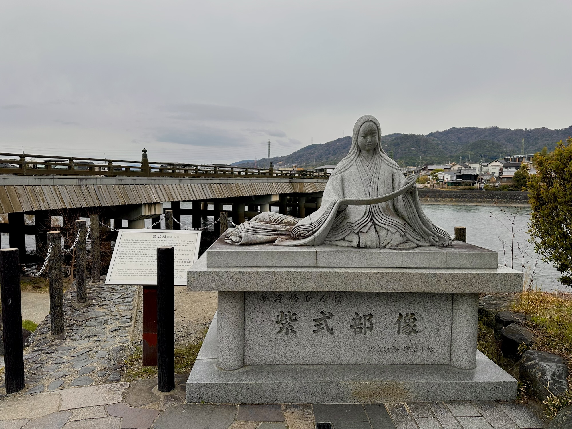 Statue of Murasaki Shikibu beside Uji Bridge overlooking the river in Uji