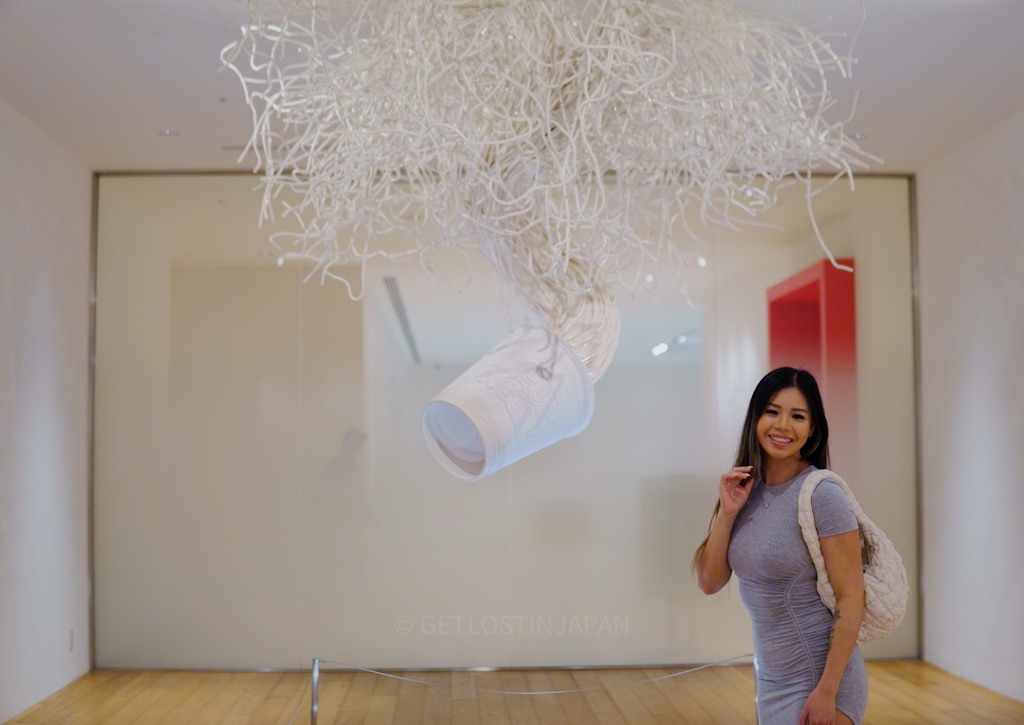 Audrey posing inside the Cup Noodles Museum next to a large art installation during a one day trip near Tokyo.
