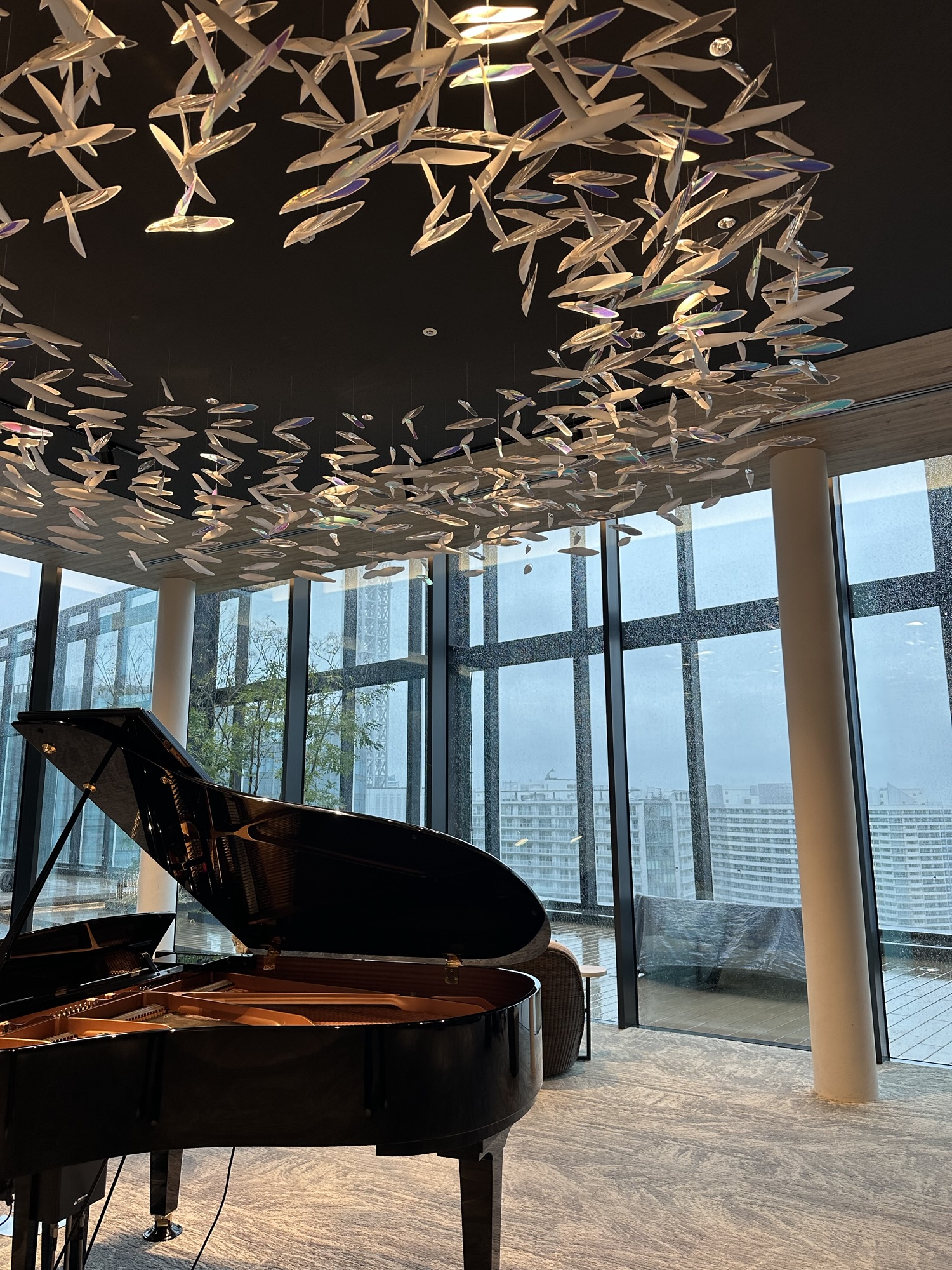 Grand piano and hanging art installation inside the lobby of Mitsui Garden Yokohama Minatomirai Premier.